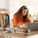 Woman on computer optimizing logistics outsourcing
